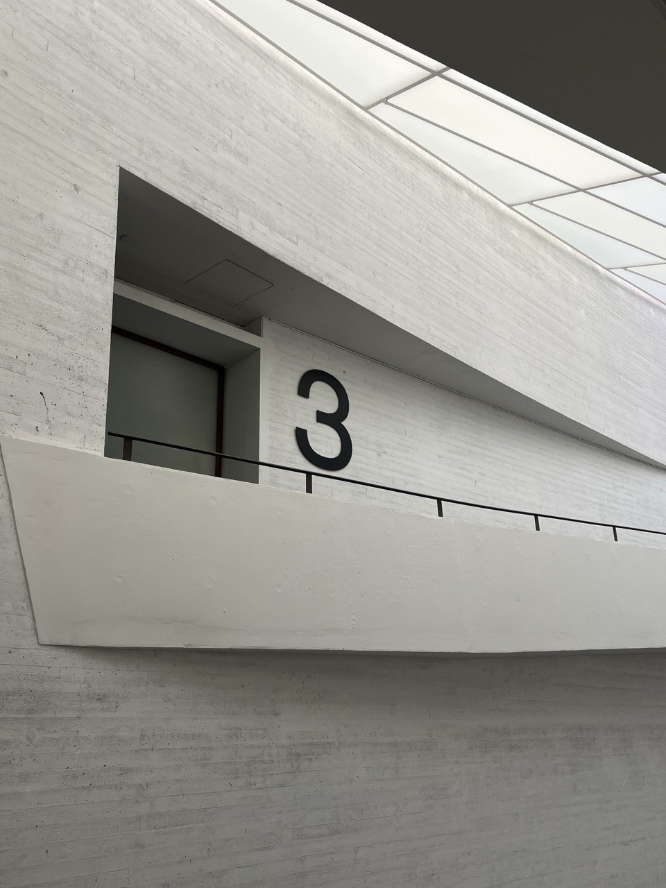 Concrete interior balcony with a large number three