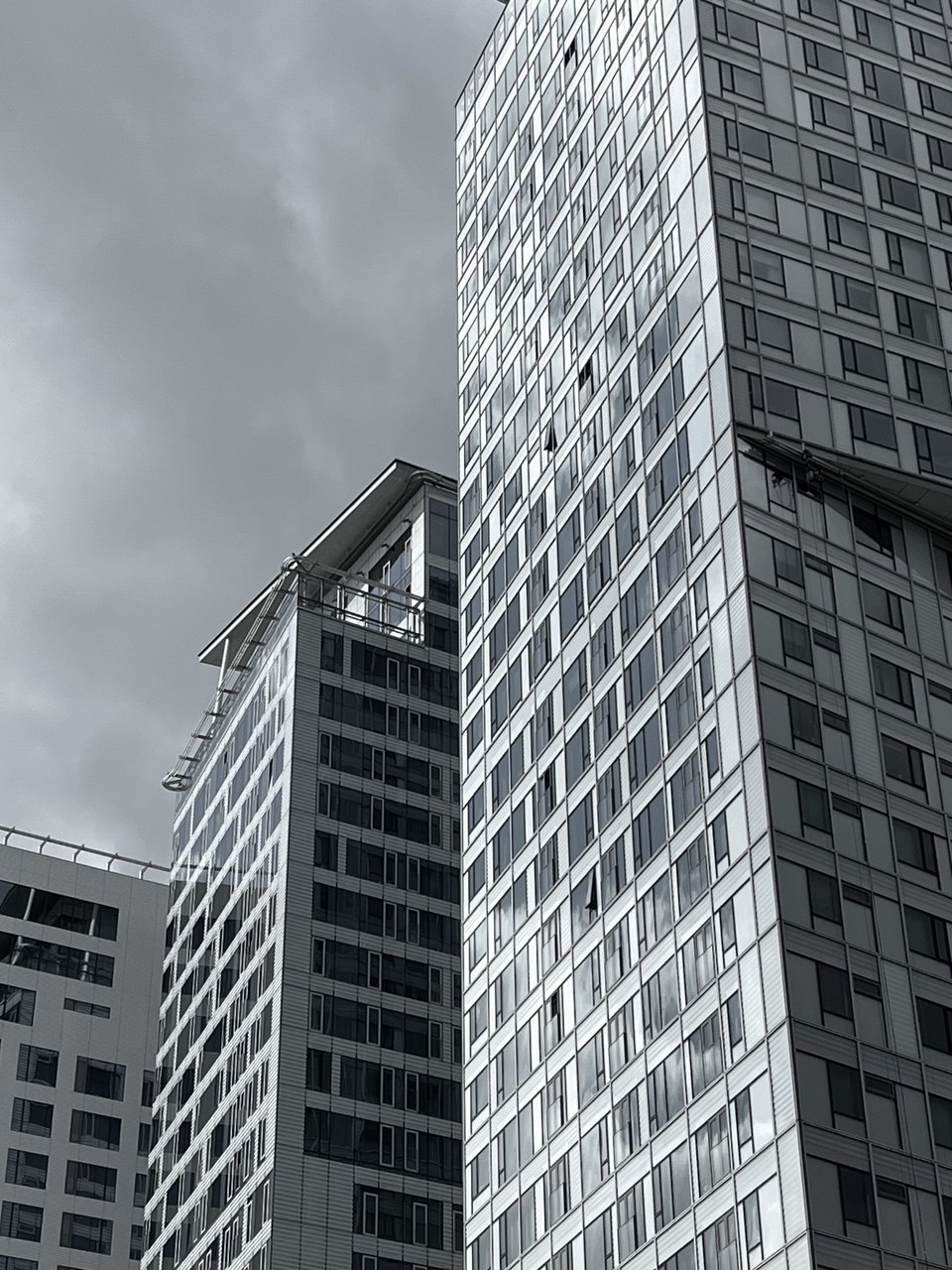Tall city buildings under an overcast sky