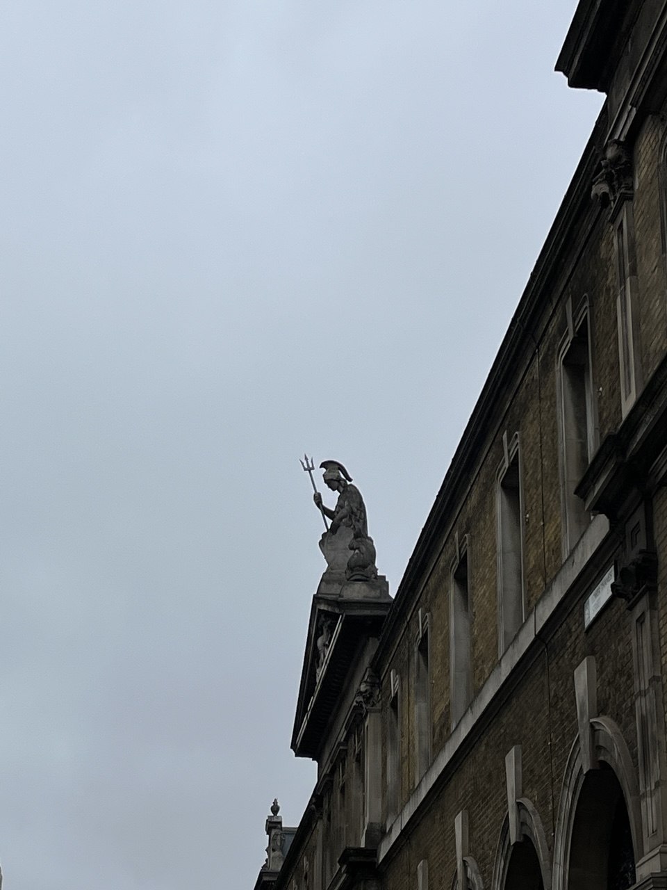 Historic building facade with a rooftop statue
